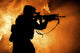 Silhouette of a modern infantry soldier with an assault rifle on a colored background poster print.