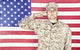 U.S. soldier in camouflage uniform saluting American flag poster print.