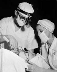 Poster print of a patient receiving treatment from two oral surgeons.