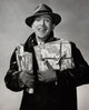 Portrait of a mid adult man smiling while holding Christmas presents.