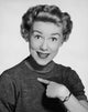 Portrait of a young woman pointing to herself - poster print