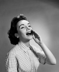 Close-up poster print of a young woman shouting with hand near mouth.