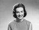 Portrait of a young woman smiling poster print showcasing joy and warmth.