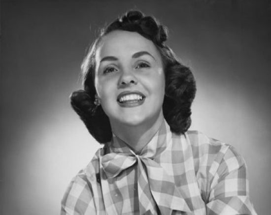 Close-up poster print of a young woman smiling, showcasing joy and warmth.