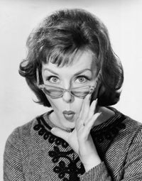 Portrait of a young woman puckering with hand near mouth poster print