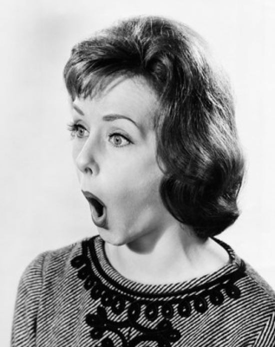 Young woman looking surprised poster print, available in multiple sizes.