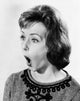 Young woman looking surprised poster print, available in multiple sizes.