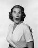 Portrait of a young woman looking surprised poster print