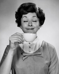 Portrait of a young woman enjoying a cup of tea poster print.
