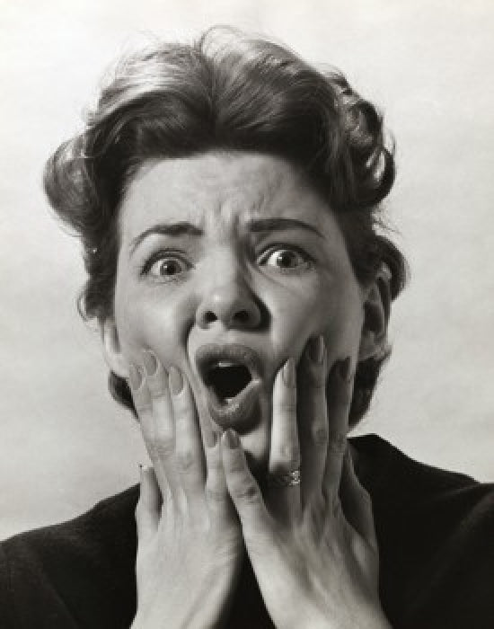 Portrait of a mid adult woman looking alarmed poster print
