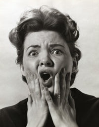 Portrait of a mid adult woman looking alarmed poster print