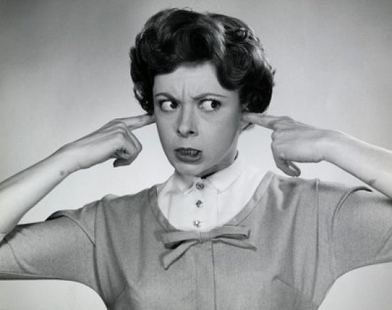 Portrait of a young woman with fingers in ears - Poster Print
