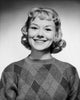 Portrait of a young woman smiling poster print showcasing happiness and joy.