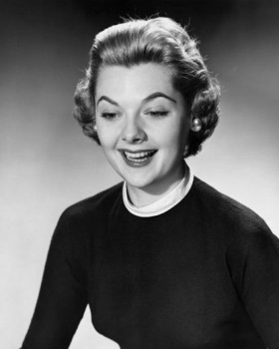 Close-up poster print of a young woman smiling, showcasing happiness and warmth.