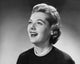Close-up poster print of a young woman laughing, showcasing joy and happiness.
