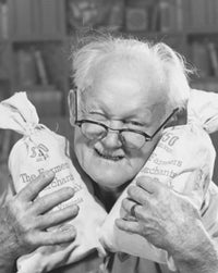 Portrait of a Senior Man Holding Two Bags of Money Poster Print