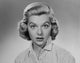 Portrait of a young woman looking surprised poster print.