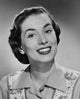 Studio portrait of a young woman smiling, vibrant and charming poster print.
