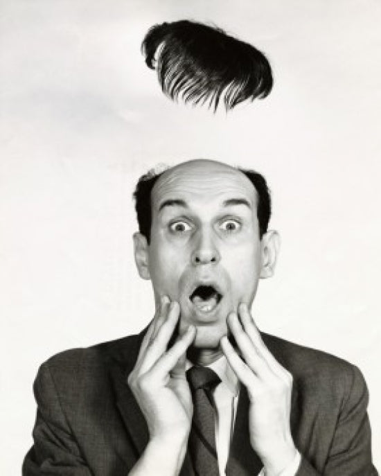 Poster print of a surprised businessman with a flying toupee.