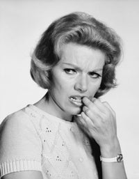 Close-up poster print of a mature woman with her finger in her mouth.