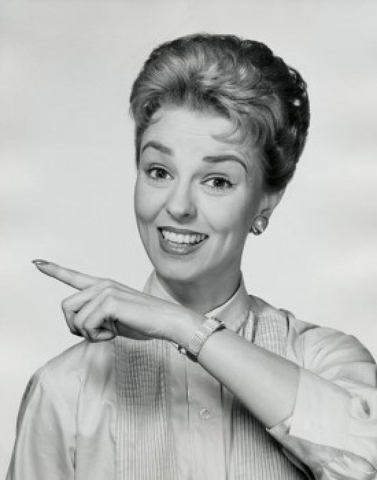 Portrait of a mid adult woman smiling and pointing her finger poster print.