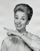 Portrait of a mid adult woman smiling and pointing her finger poster print.