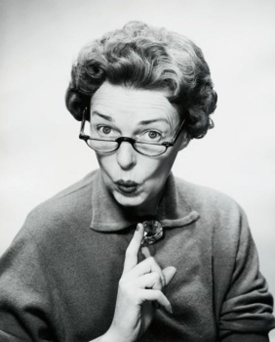 Close-up poster print of a mid-adult woman puckering her lips.