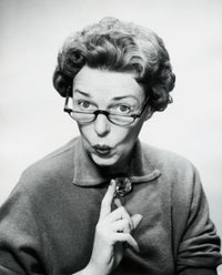 Close-up poster print of a mid-adult woman puckering her lips.