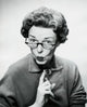 Close-up poster print of a mid-adult woman puckering her lips.