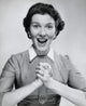Portrait of a surprised mid-adult woman with clasped hands poster print