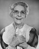 Close-up poster print of a senior woman smiling while holding paper.