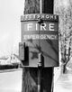 Close-up fire alarm mounted on a wooden post poster print