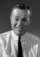 Studio portrait of a smiling businessman, perfect for office decor.