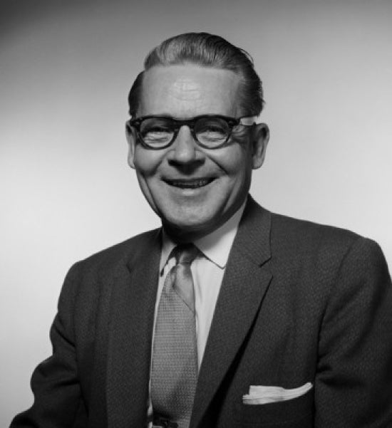 Portrait of a smiling businessman in a studio setting, perfect for office decor.