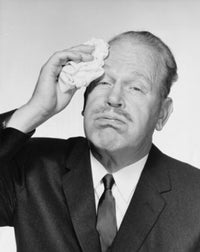 Portrait of a businessman wiping sweat from his forehead poster print.
