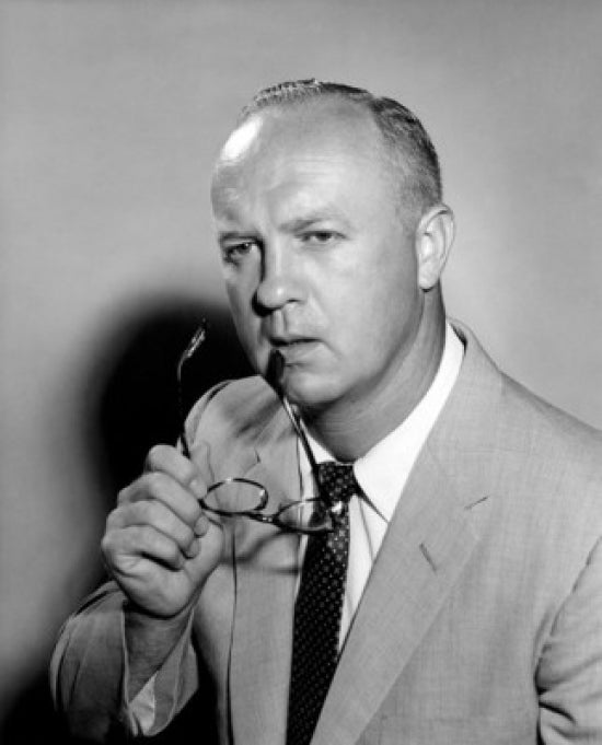 Pensive businessman holding glasses poster print