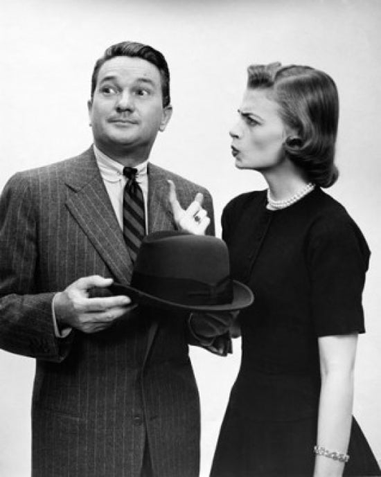 Young woman pointing at a man poster print available in multiple sizes.