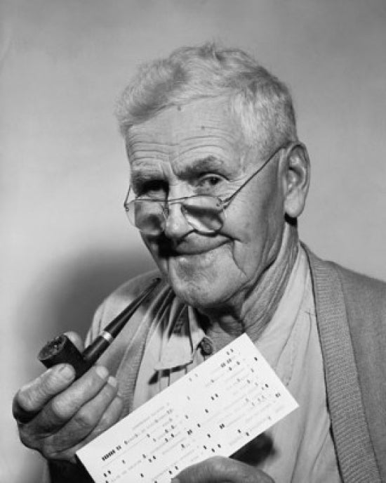 Close-up of a senior man holding a check and a pipe poster print.