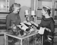 Female sales clerk showcasing jewelry poster print