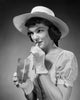 Close-up of a young woman drinking lemonade, vibrant artwork.