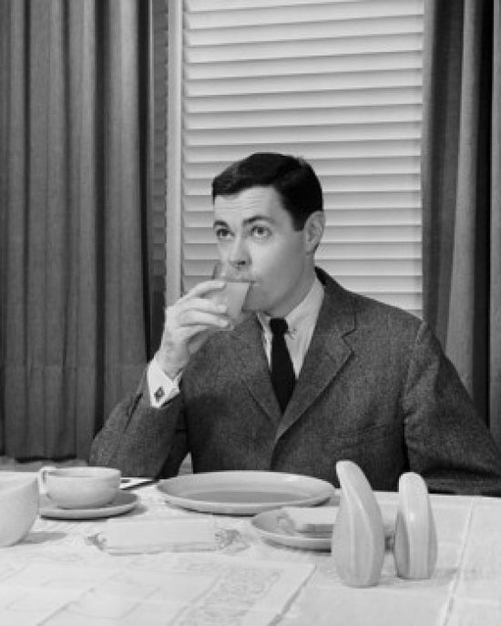 Mid adult man drinking juice poster print, vibrant and refreshing wall art.