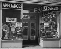 Appliances in a window display poster print showcasing modern electronics.