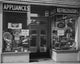 Appliances in a window display poster print showcasing modern electronics.