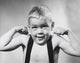 Studio portrait of a boy flexing muscles, inspiring artwork for kids' rooms.