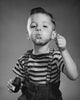 Portrait of boy blowing bubbles with bubble wand poster print