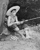 Boy holding a fishing rod poster print, capturing childhood joy and adventure.