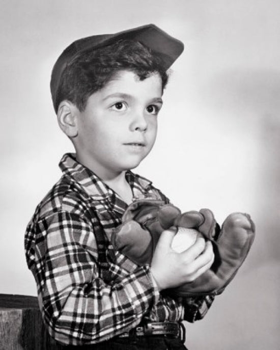 Close-up of a boy holding a baseball and glove poster print.