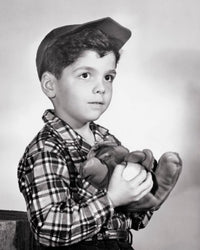 Close-up of a boy holding a baseball and glove poster print.