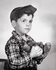 Close-up of a boy holding a baseball and glove poster print.