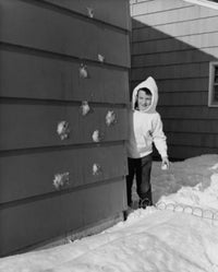 Boy Standing Behind a Wall Poster Print showcasing youthful imagination.